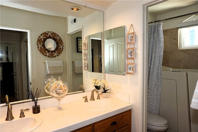 bathroom with vanity, curtained shower, and toilet