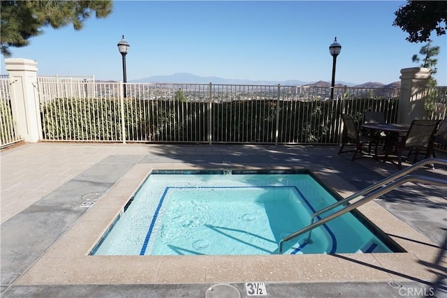 view of pool featuring a mountain view and a patio area