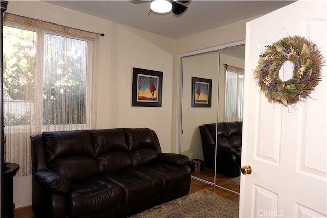 living room featuring hardwood / wood-style floors and ceiling fan