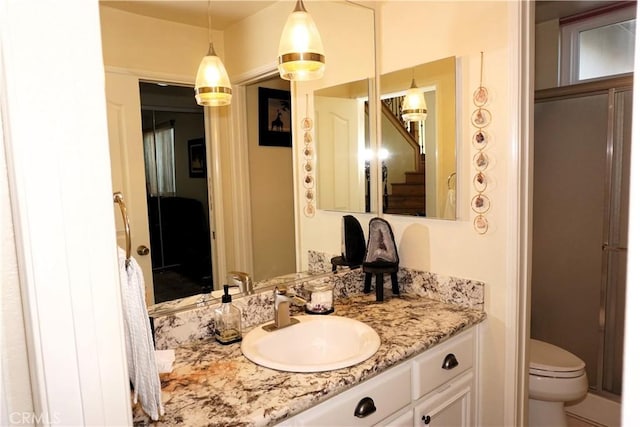 bathroom featuring vanity and toilet