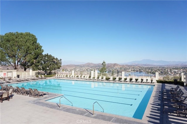 view of pool with a mountain view and a patio