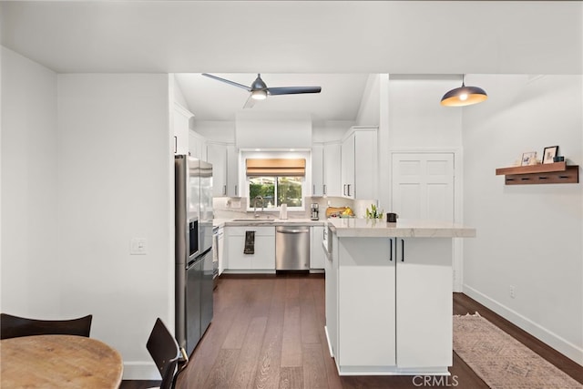 kitchen with white cabinets, a kitchen bar, sink, and stainless steel appliances