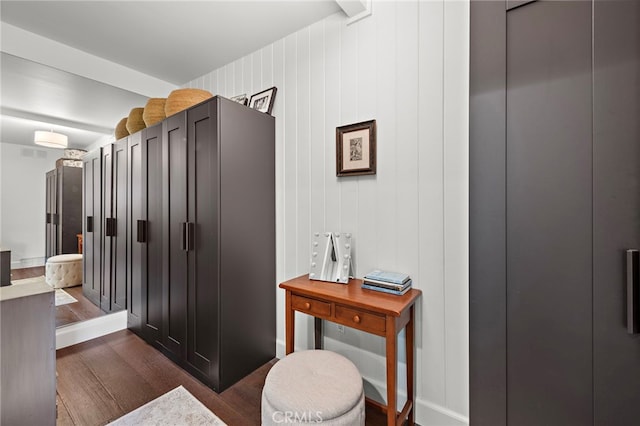 bathroom featuring hardwood / wood-style floors and wood walls