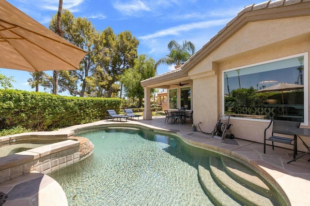 view of pool featuring an in ground hot tub and a patio