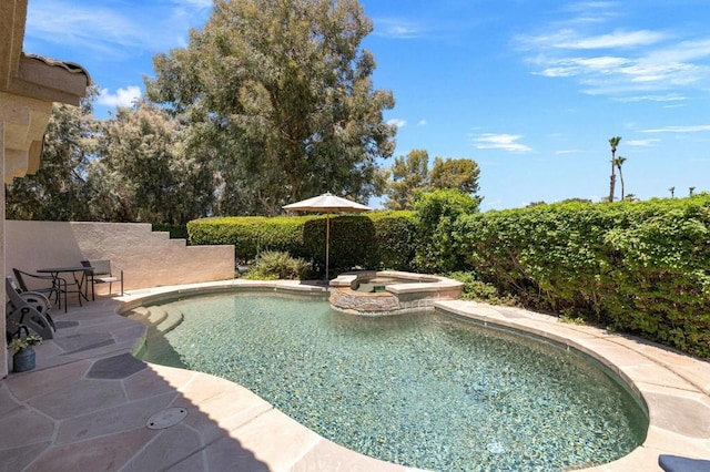 view of swimming pool with a patio area and an in ground hot tub