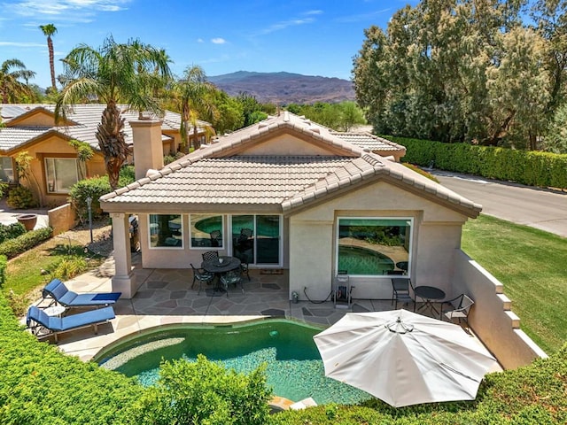 back of house featuring a patio area and a mountain view