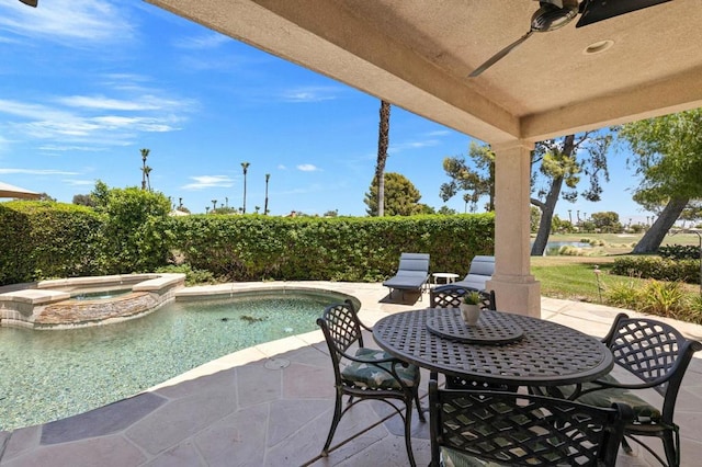 view of patio / terrace featuring ceiling fan and a pool with hot tub