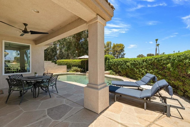 view of patio / terrace with a fenced in pool and ceiling fan