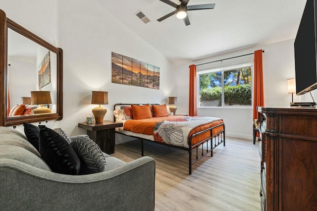 bedroom with vaulted ceiling, ceiling fan, and light hardwood / wood-style flooring