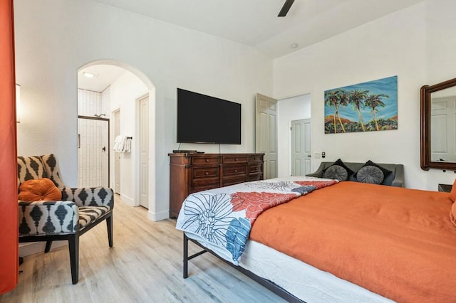 bedroom featuring ceiling fan, lofted ceiling, and light hardwood / wood-style flooring