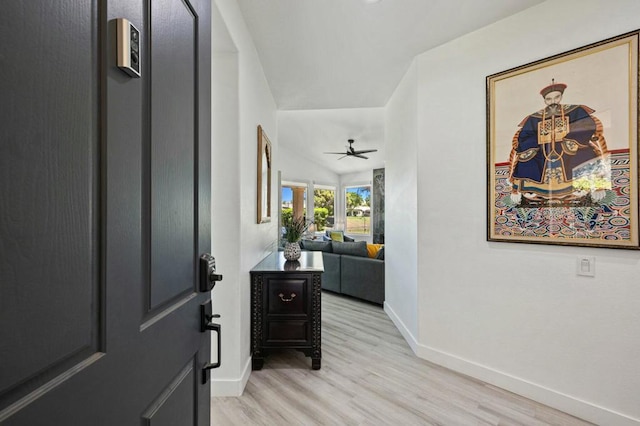 foyer entrance featuring vaulted ceiling, ceiling fan, and light hardwood / wood-style floors