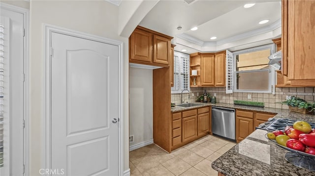 kitchen with appliances with stainless steel finishes, dark stone countertops, sink, light tile patterned flooring, and a tray ceiling