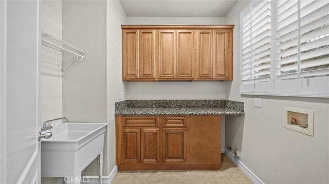 laundry area with washer hookup, cabinets, a healthy amount of sunlight, and sink