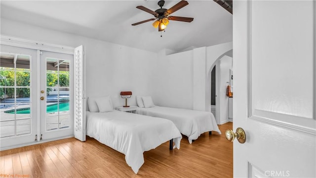 bedroom featuring ceiling fan, lofted ceiling, access to exterior, and light hardwood / wood-style flooring