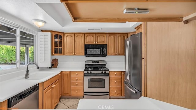 kitchen featuring sink, stainless steel appliances, and light tile patterned flooring