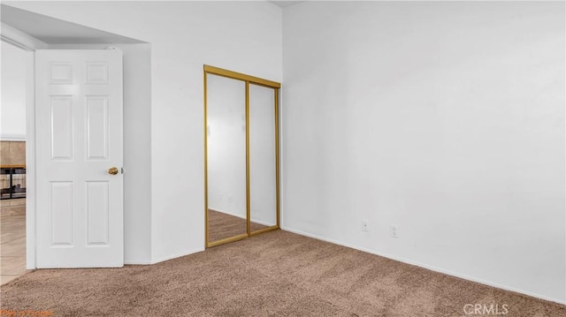 unfurnished bedroom with carpet floors and a closet