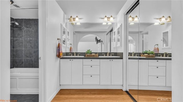 bathroom featuring hardwood / wood-style flooring, vanity, and independent shower and bath