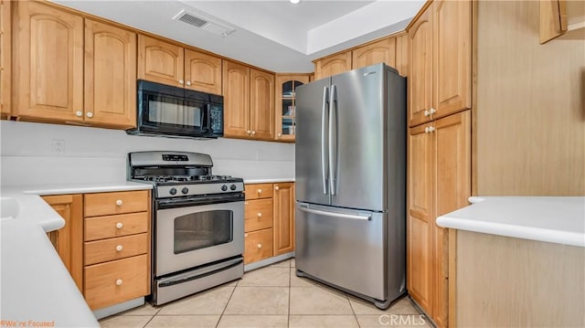 kitchen with stainless steel appliances and light tile patterned flooring