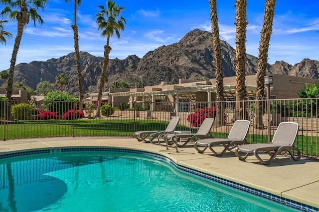 view of swimming pool featuring a mountain view and a yard