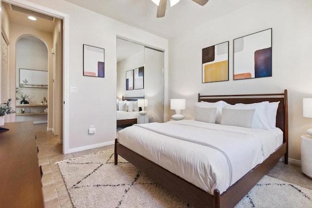 bedroom with ceiling fan and a closet