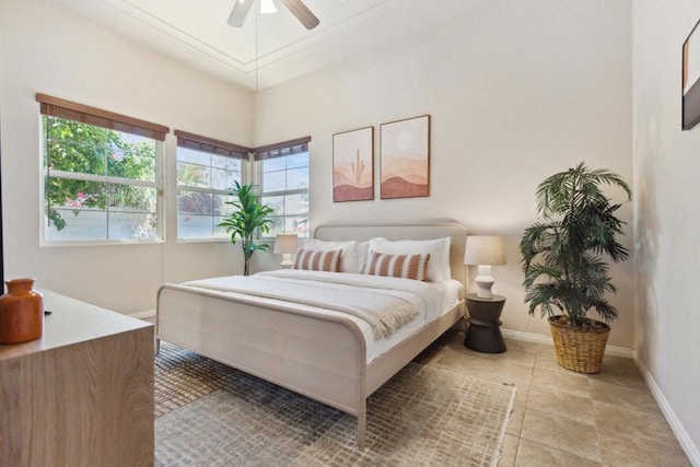 tiled bedroom featuring ceiling fan