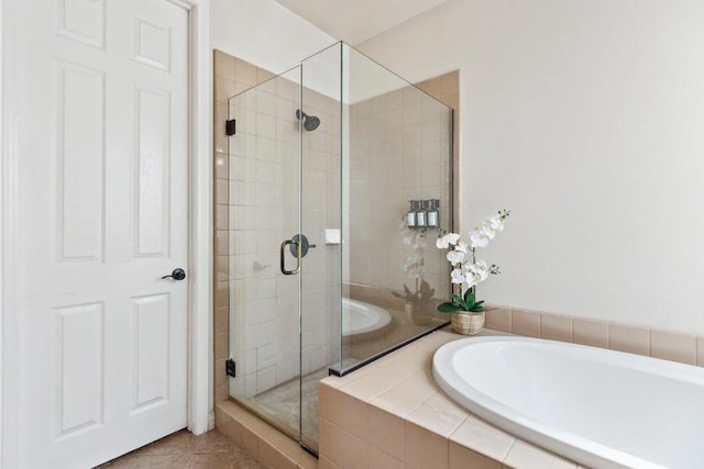 bathroom with independent shower and bath and tile patterned floors