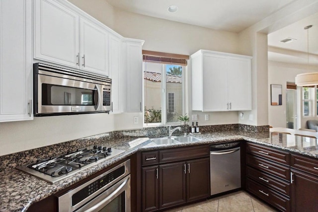 kitchen with sink, white cabinets, stainless steel appliances, and a healthy amount of sunlight