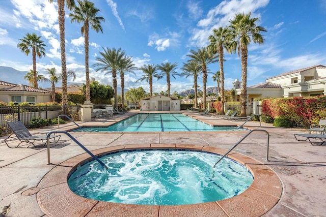 view of swimming pool with a community hot tub and a patio