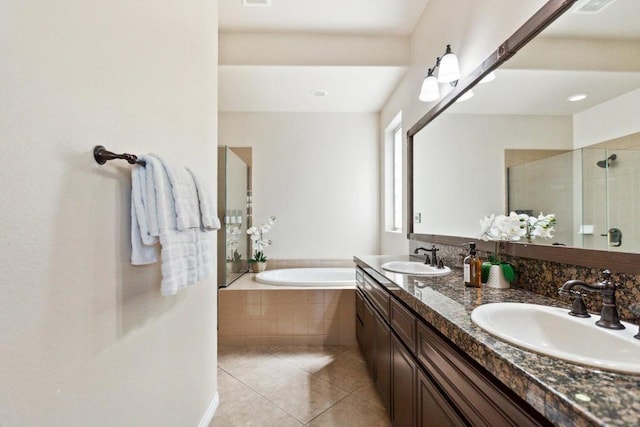 bathroom featuring plus walk in shower, tile patterned floors, and vanity