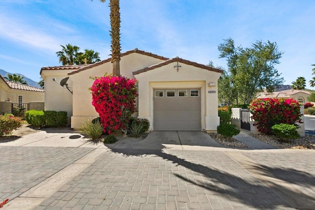 mediterranean / spanish-style home with a garage