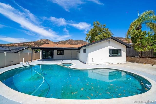 view of swimming pool featuring a mountain view and a patio area