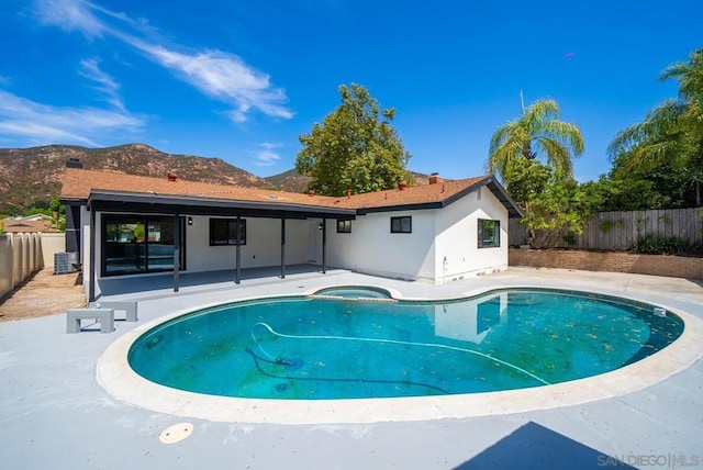 view of swimming pool with a patio, a mountain view, and central AC unit