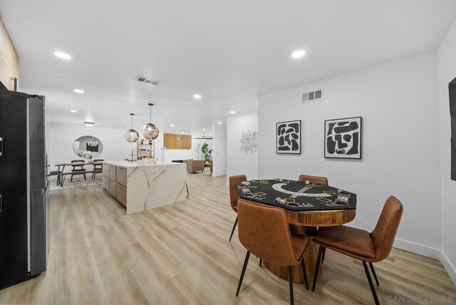 dining space featuring light wood-type flooring