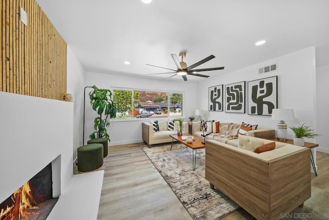 living room featuring ceiling fan and light wood-type flooring