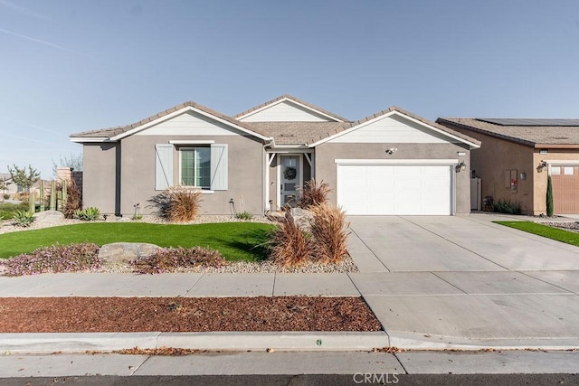 ranch-style home featuring a garage and a front lawn