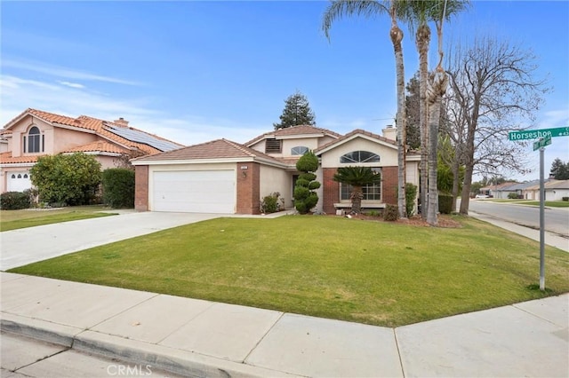 mediterranean / spanish house with a front yard and a garage