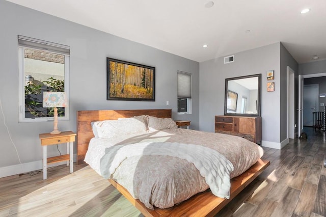 bedroom with hardwood / wood-style floors