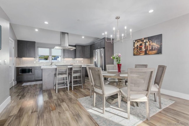 dining area featuring a chandelier and light hardwood / wood-style floors