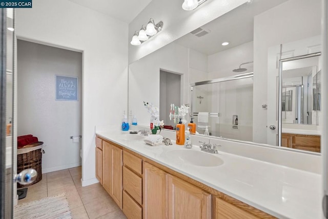 bathroom with tile patterned flooring, vanity, a shower with shower door, and toilet