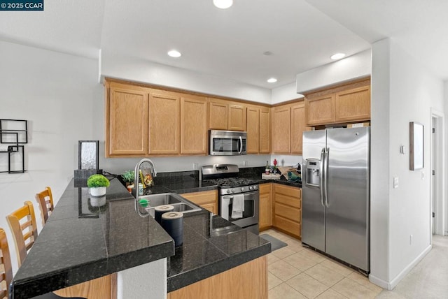 kitchen featuring sink, light brown cabinets, light tile patterned floors, kitchen peninsula, and stainless steel appliances