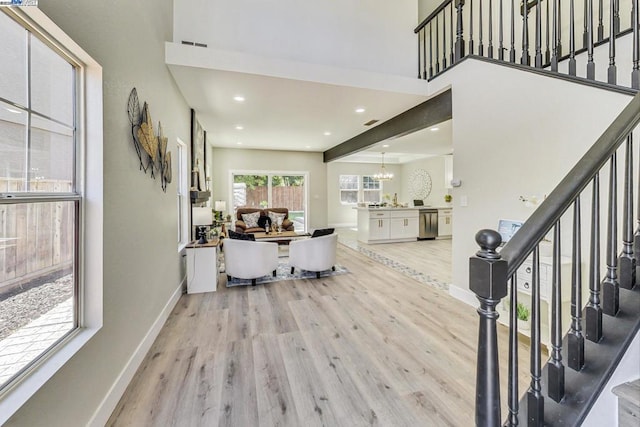 interior space featuring light wood-type flooring and an inviting chandelier