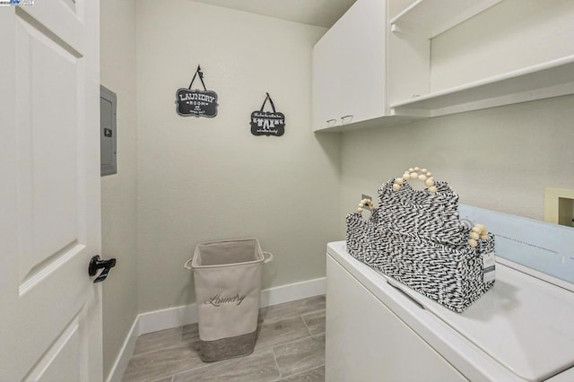 clothes washing area with cabinets