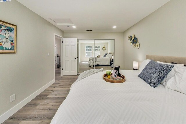 bedroom featuring a closet and light hardwood / wood-style flooring