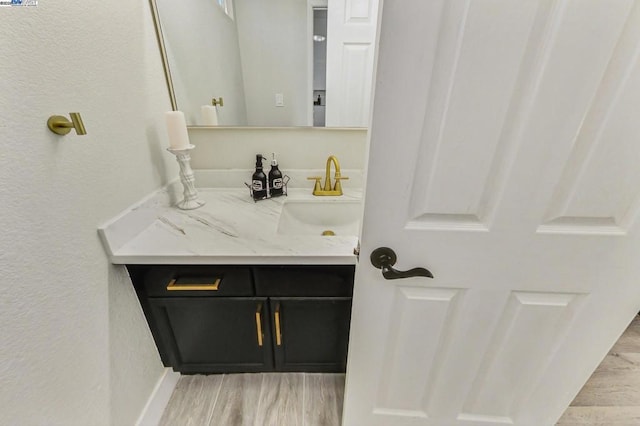 bathroom featuring hardwood / wood-style flooring and vanity