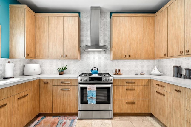 kitchen with light brown cabinetry, stainless steel stove, wall chimney exhaust hood, and decorative backsplash