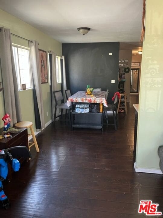 dining space with dark hardwood / wood-style floors