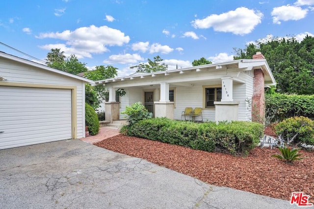 view of front of property with a porch and a garage