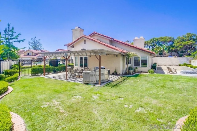 rear view of house with a pergola, a yard, and a patio