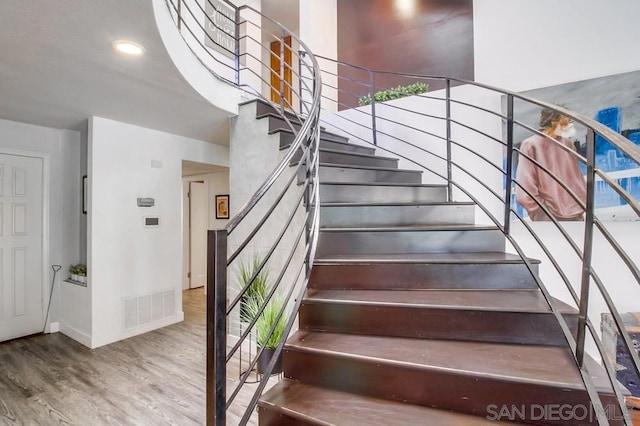 staircase with wood-type flooring