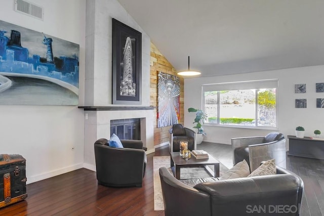 living room with dark hardwood / wood-style floors and vaulted ceiling